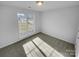 Sunny bedroom with carpet and a window overlooking the outdoors at 2115 Windy Hill Ln, Monroe, NC 28110