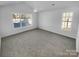 Large bedroom with carpet and multiple windows at 2115 Windy Hill Ln, Monroe, NC 28110