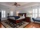 Main bedroom with hardwood floors, large windows, and ensuite bathroom at 21711 Shoveller Ct, Cornelius, NC 28031