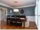 Formal dining room with hardwood floors, chandelier, and large windows at 21711 Shoveller Ct, Cornelius, NC 28031