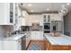 Modern kitchen with white cabinets, stainless steel appliances, and a large island at 21711 Shoveller Ct, Cornelius, NC 28031