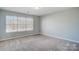 Bedroom with carpeted floor and large window at 2224 Apple Glen Ln, Charlotte, NC 28269