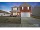 Brick two-story house with a two-car garage and landscaping at 2224 Apple Glen Ln, Charlotte, NC 28269