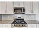 Stainless steel range and microwave in a kitchen with granite countertops at 2224 Apple Glen Ln, Charlotte, NC 28269