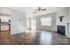 Open living room and kitchen with hardwood floors and a fireplace at 2224 Apple Glen Ln, Charlotte, NC 28269