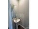 Small powder room with pedestal sink and mirror at 2255 Transatlantic Ave, Charlotte, NC 28215