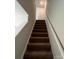 Modern carpeted staircase with neutral walls and simple handrail at 2255 Transatlantic Ave, Charlotte, NC 28215