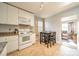 Kitchen with white cabinets, granite counters, and breakfast table at 2516 Columbus Cir, Charlotte, NC 28208