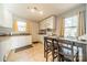 Kitchen with white cabinets, granite counters, and breakfast table at 2516 Columbus Cir, Charlotte, NC 28208