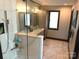 Modern bathroom with double vanity, glass shower, and marble floors at 2579 Ranger Island Rd, Denver, NC 28037