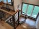 Modern staircase with cable railing and hardwood floors at 2579 Ranger Island Rd, Denver, NC 28037