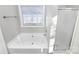 Relaxing bathroom with soaking tub and glass-enclosed shower at 2820 Rosemeade Dr, Monroe, NC 28110