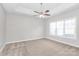 Spacious, neutral bedroom with carpeted floors, ceiling fan, and a large window at 2820 Rosemeade Dr, Monroe, NC 28110