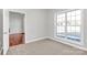 Neutral bedroom with carpeted floors, white trim and doors, and large windows at 2820 Rosemeade Dr, Monroe, NC 28110