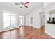 Bright living area with a large window, ceiling fan, laminate floors and a white door at 2820 Rosemeade Dr, Monroe, NC 28110