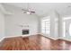 Spacious living room with a fireplace, large windows, ceiling fan and laminate floors at 2820 Rosemeade Dr, Monroe, NC 28110