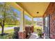 Covered front porch with brick columns and wicker furniture at 2943 Tallgrass Blf, Rock Hill, SC 29732