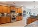 Modern kitchen with wood cabinets, stainless steel appliances and tile backsplash at 2943 Tallgrass Blf, Rock Hill, SC 29732