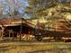 Elevated deck, brick home, and partial view of yard at 3326 Winterfield Pl, Charlotte, NC 28205