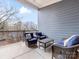 Private balcony with wicker furniture and treetop views at 3551 Spencer St, Charlotte, NC 28205