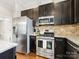 Modern kitchen with stainless steel appliances and dark cabinets at 3551 Spencer St, Charlotte, NC 28205