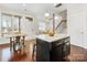 Island kitchen with view of entryway and staircase at 3551 Spencer St, Charlotte, NC 28205