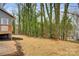 Partially wooded backyard with mulch and small deck at 3711 Indian Ct, Lenoir, NC 28601