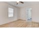 Bedroom with wood flooring, ceiling fan, and an ensuite bathroom at 3711 Indian Ct, Lenoir, NC 28601