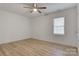 Simple bedroom with light walls, wood flooring and ceiling fan at 3711 Indian Ct, Lenoir, NC 28601