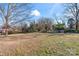 Large backyard with a grassy area and a partial view of a red shed at 410 7Th St, Spencer, NC 28159