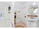 Clean bathroom with white vanity, bathtub, and neutral tile floors at 410 7Th St, Spencer, NC 28159