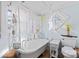 Bathroom with clawfoot tub, shower, and unique window at 410 7Th St, Spencer, NC 28159