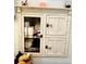 Bathroom linen closet with glass-paned door and wooden shelving at 410 7Th St, Spencer, NC 28159