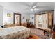 Charming bedroom with hardwood floors, ceiling fan, and antique wardrobe at 410 7Th St, Spencer, NC 28159