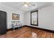 Simple bedroom with hardwood floors, ceiling fan and neutral walls at 410 7Th St, Spencer, NC 28159