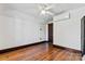 Empty bedroom featuring hardwood floors, ceiling fan and door at 410 7Th St, Spencer, NC 28159