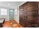 Inviting entryway with hardwood floors and coat bench at 410 7Th St, Spencer, NC 28159