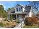 Charming house with white siding, gray roof, and a picket fence at 410 7Th St, Spencer, NC 28159