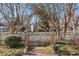 Pathway to the house through a charming arch and picket fence at 410 7Th St, Spencer, NC 28159