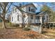 Side view of the house showcasing the white siding and a small picket fence at 410 7Th St, Spencer, NC 28159