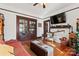 Living room with hardwood floors, fireplace, and a large TV at 410 7Th St, Spencer, NC 28159