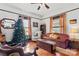 Living area with hardwood floors, comfortable seating, and a Christmas tree at 410 7Th St, Spencer, NC 28159