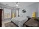 Main bedroom with king-size bed, ceiling fan, and plenty of natural light at 4126 Walker Rd, Charlotte, NC 28211