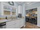 Kitchen with granite counters, double sink, and laundry area at 4126 Walker Rd, Charlotte, NC 28211