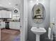 Stylish powder room with pedestal sink and leaf-patterned wallpaper at 4126 Walker Rd, Charlotte, NC 28211