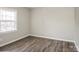 Spacious bedroom with neutral walls and wood-look floors at 4762 Old Lantern Way, Charlotte, NC 28212