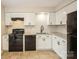 Modern kitchen with white cabinets, granite counters, and black appliances at 4762 Old Lantern Way, Charlotte, NC 28212