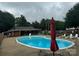 Community swimming pool with lounge chairs and shaded area at 4762 Old Lantern Way, Charlotte, NC 28212