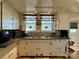 Kitchen with white cabinets, double sink, and tiled backsplash at 503 E 10Th St, Kannapolis, NC 28083