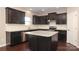 Modern kitchen with dark wood cabinets and granite island at 5030 Monacan Way, Indian Land, SC 29707